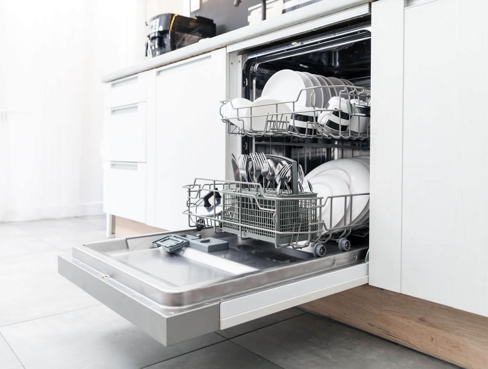 An open dishwasher full of dishes - ACR repairs Bosch dishwashers. Call (505) 591-9590 now!